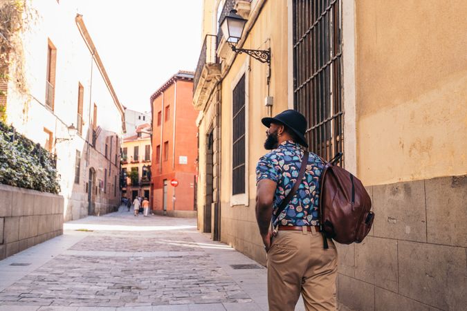 Stylish Black man walking on the city street