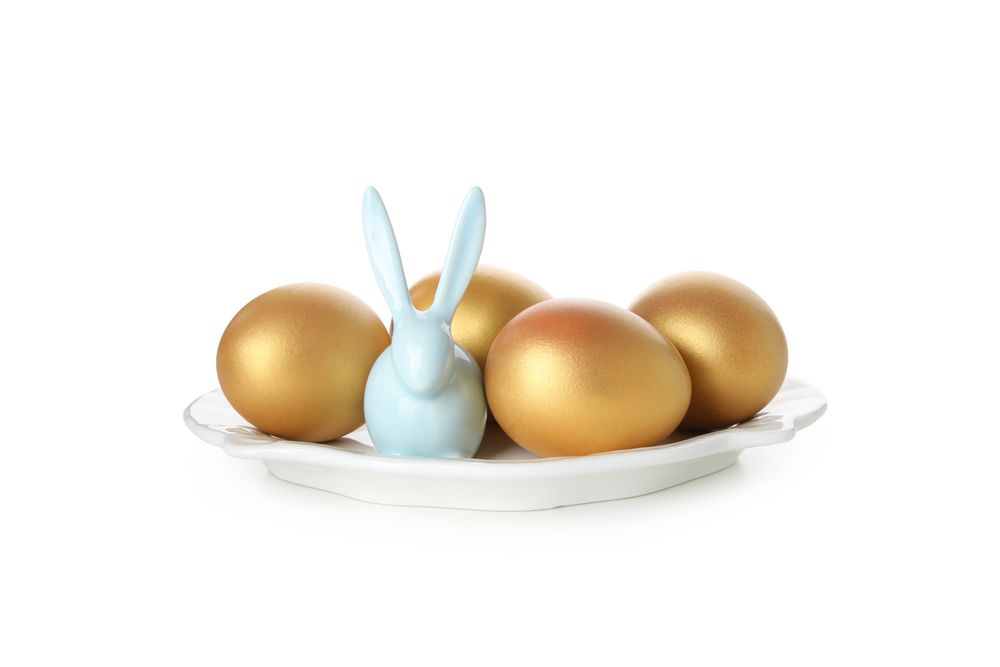 Concept of Richness, golden eggs, isolated on blank background