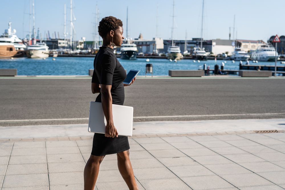Black woman using mobile phone on the street