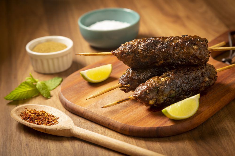 Beef kafta on the wooden board. Kafta, Traditional Arabic cuisine.