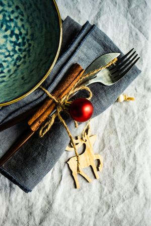 Christmas table setting with cutlery wrapped with cinnamon stick
