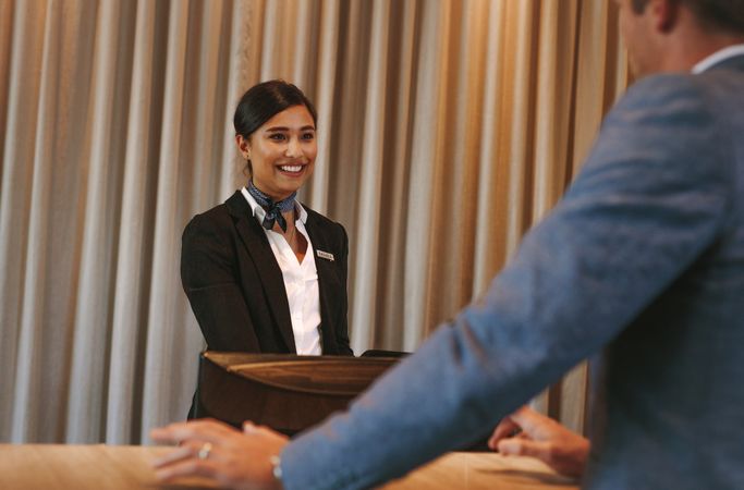 Concierge helping guest with hotel room bookings