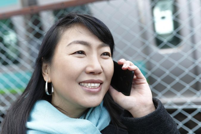 East Asian woman having a phone call outdoor