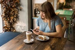 Woman using smartphone in cafe