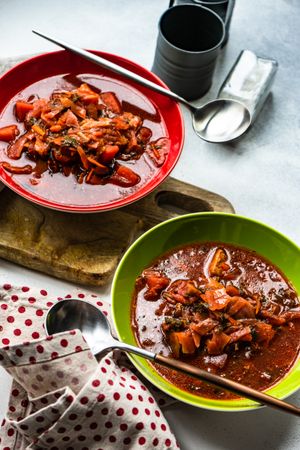 Two bowls of traditional Ukrainian beetroot soup borscht