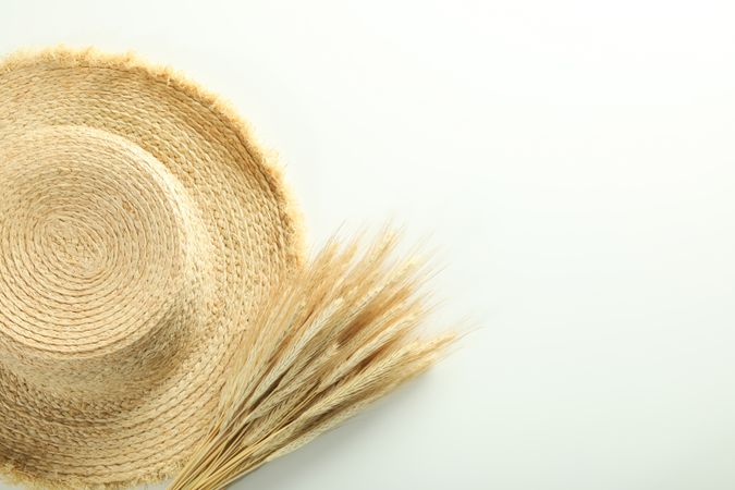 Top view of hat and bunch of dried flowers with copy space