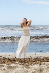 Charming young woman on shore near water