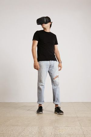 Man standing wearing VR headset