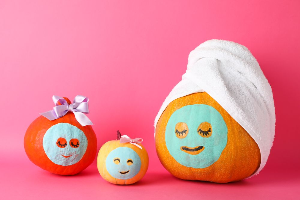 Funny pumpkins on pink background. Body care