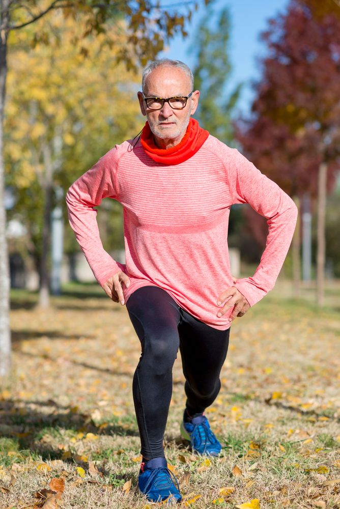 Male doing lunges in park to work out