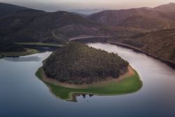 Small island on lake in mountain landscape