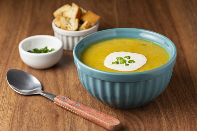 Bowl with pumpkin soup on the table.
