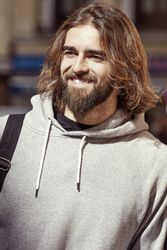 man smiling and looking along