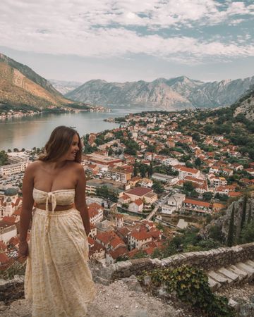 Woman posing on hill beside Kotor Fortress, Montenegro