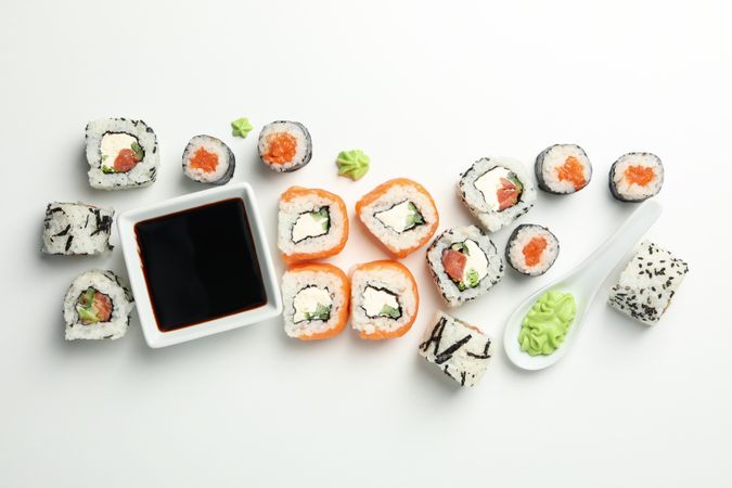 Delicious sushi rolls on plain background, top view. Japanese food