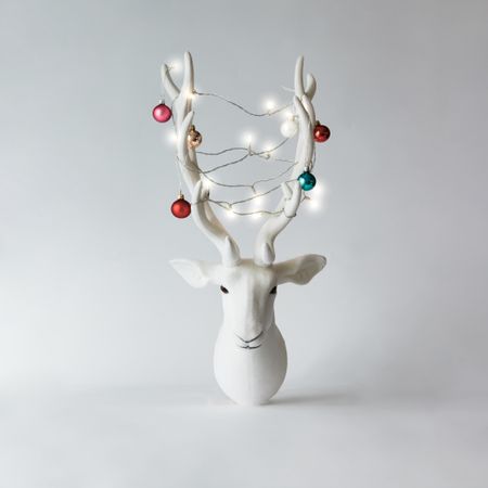 Christmas reindeer head with antlers with baubles and lights