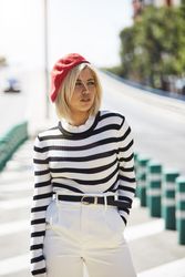female in red beret outdoors