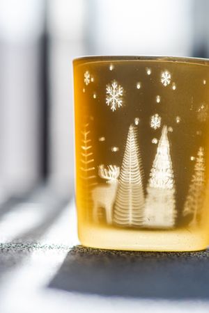 Christmas candle glass in sunny day