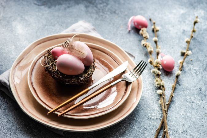Easter holiday table setting with decorative pink Easter eggs & pussy willow