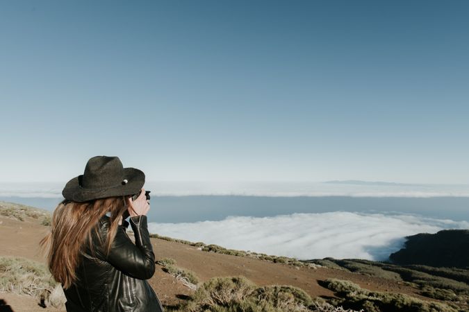 Woman with camera enjoying cloudscape