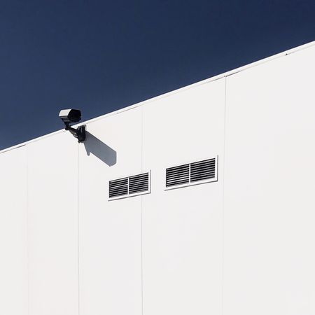 Surveillance camera on side of building