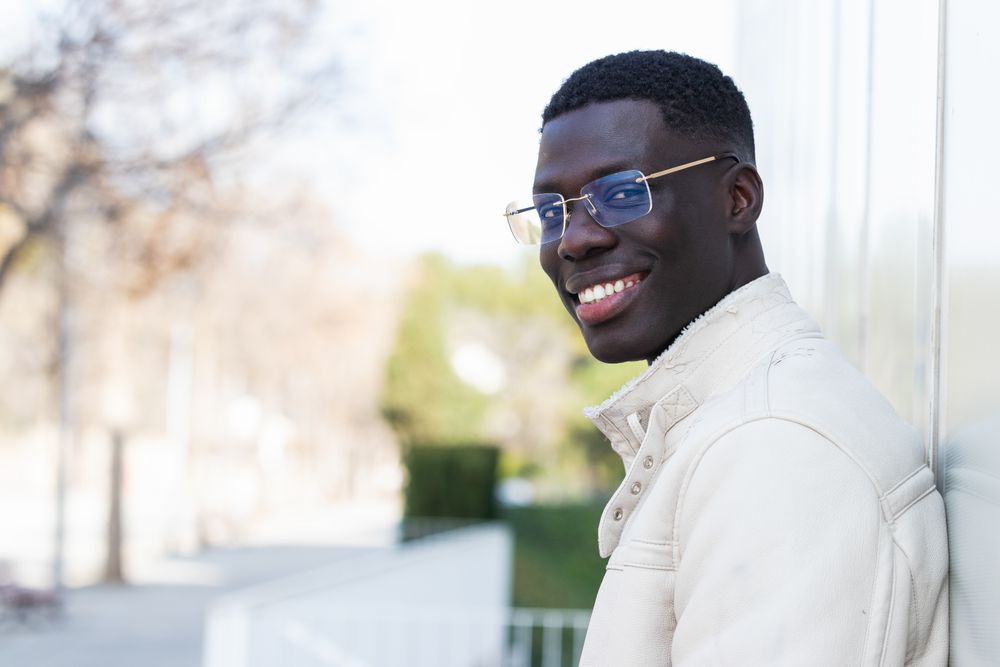 Stylish Black businessman in eyeglasses in town