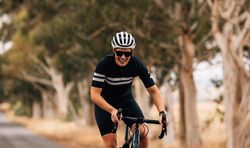 Female smiling on bicycle in middle of road