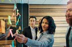 Multi-ethnic group of colleagues brainstorming with sticky notes