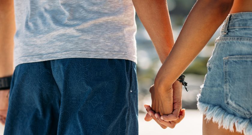 Close up of man holding hand of a woman