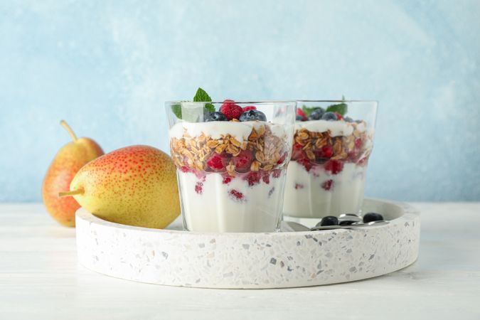Parfaits and pears on wooden table, space for text