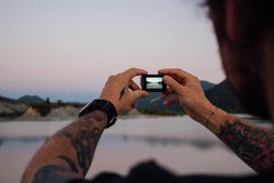 Picture of screen of man’s camera looking out at lake