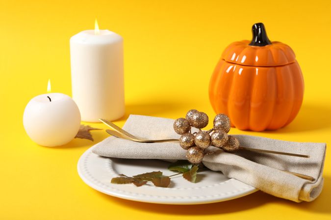 Concept of Thanksgiving day, Autumn table setting on yellow background