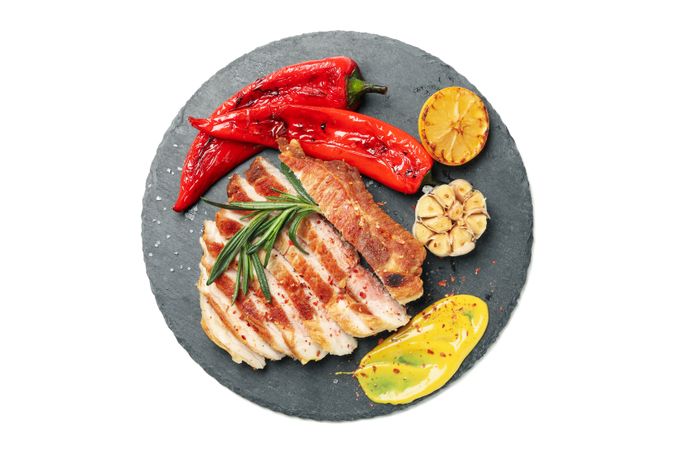 Tray with chopped pork steak isolated on light background