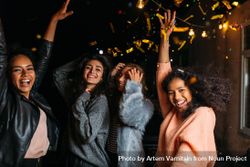 Multi-ethnic group of stylish women celebrating at night 5QdLV0