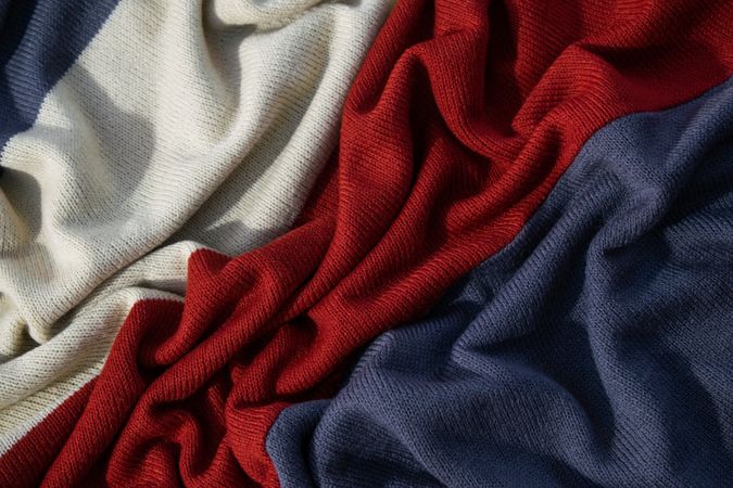 Triple color grey milk and red on knitted fabric wavy crumpled background texture.