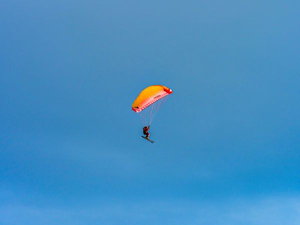 Paragliding skier, extreme sport, flying and gliding.