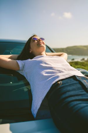 Young woman lying on the windshield
