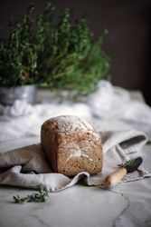 Fresh bread on napkin near tomatoes jam