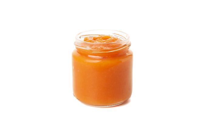 Glass jar with healthy baby food isolated on plain background