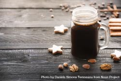 Mason jar with coffee and cookies on rustic wooden table 4ddeL4