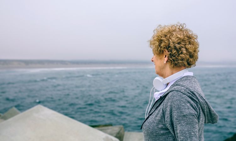 Mature sportswoman looking at the sea