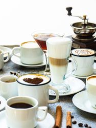 Variety of coffee drinks and garnishes on table