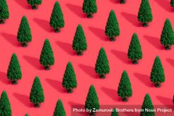 Green Christmas trees on bright salmon red background bEy6Ab
