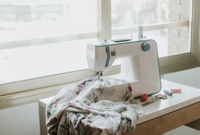 Modern sewing machine near window