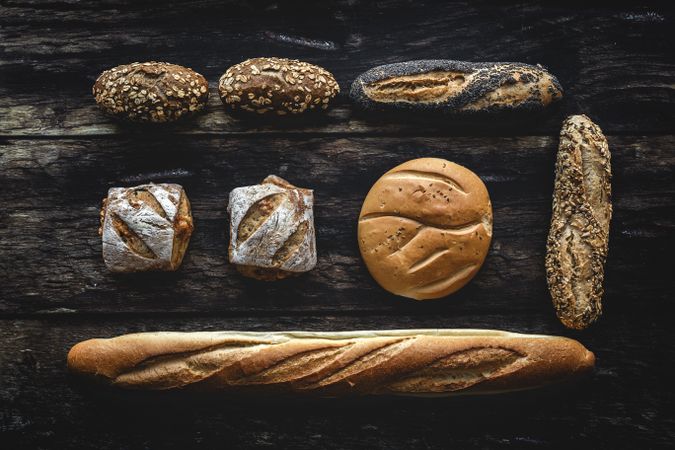 Assorted gold homemade bread on dark wood background