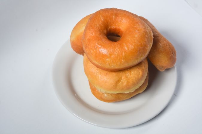 Collection of donuts on ceramic plate, isolated objects