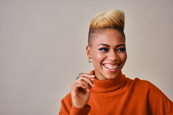 Studio shot of beautiful Black woman with short blonde hair