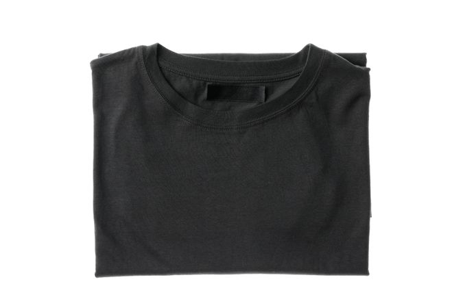 Folded dark gray t-shirt isolated on plain background, space for text