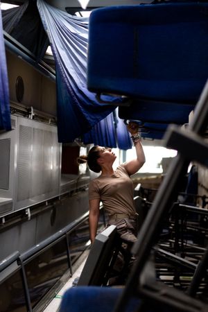 Military woman looking up inside vehicle