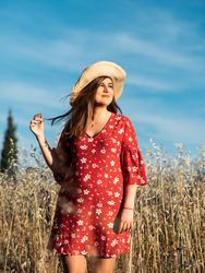 Happy dreamy woman standing among high grass
